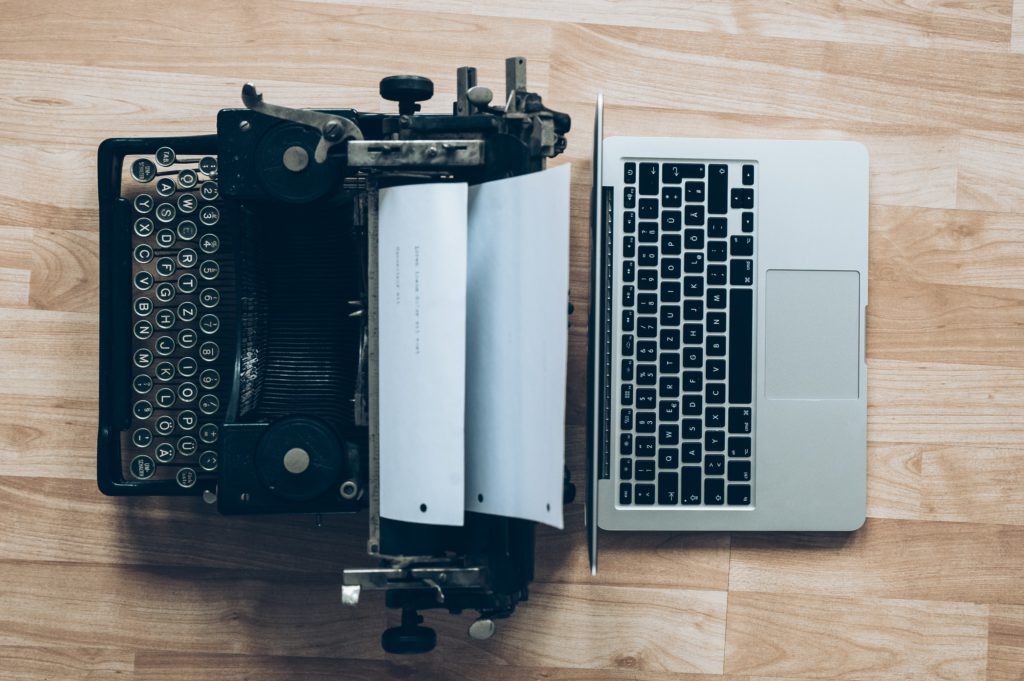 typewriter and current laptop next to each other showing need for Product testing and comparison